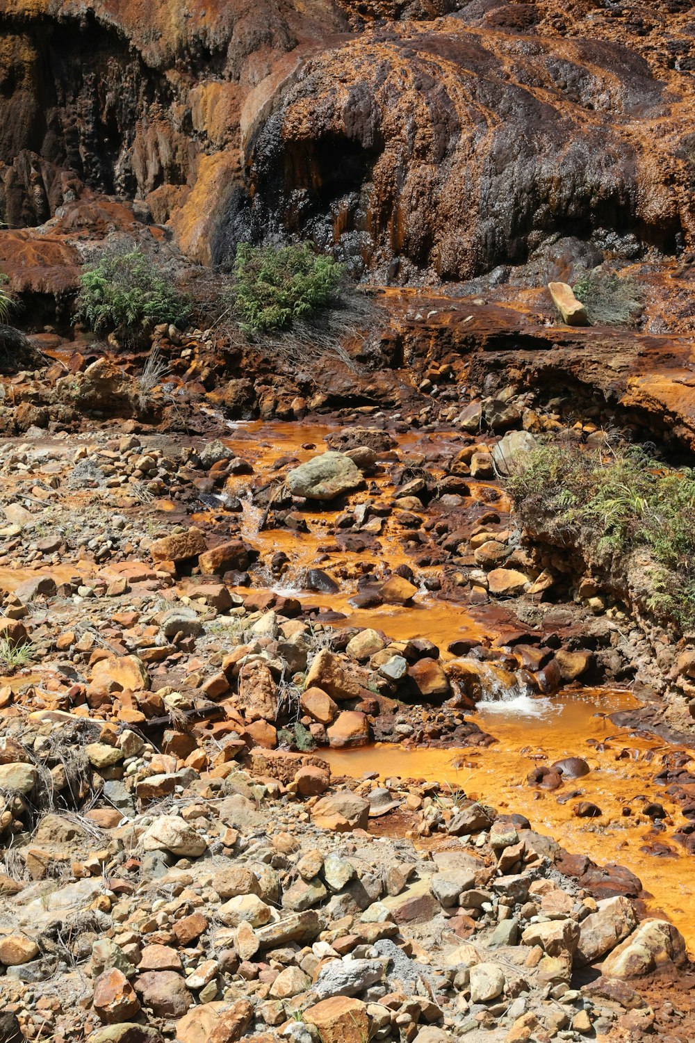 a stream of water running through a rocky area