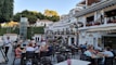 A bustling restaurant scene with happy diners enjoying their meals.