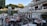 A busy restaurant with happy customers enjoying their meals at outdoor tables.