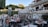 A busy restaurant with happy customers enjoying their meals at outdoor tables.