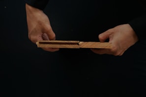 Detail of a craftsman carefully fitting laminate planks together during installation