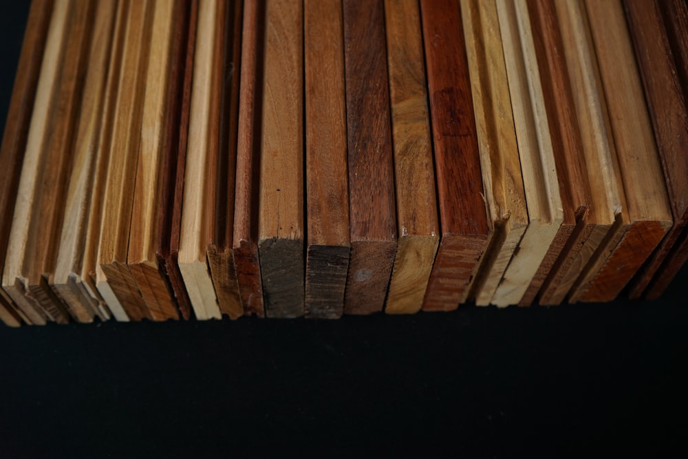 a stack of wooden planks on a black background