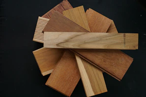 A close-up of color swatches in black, white, and wood textures arranged neatly beside a digital kitchen gadget.