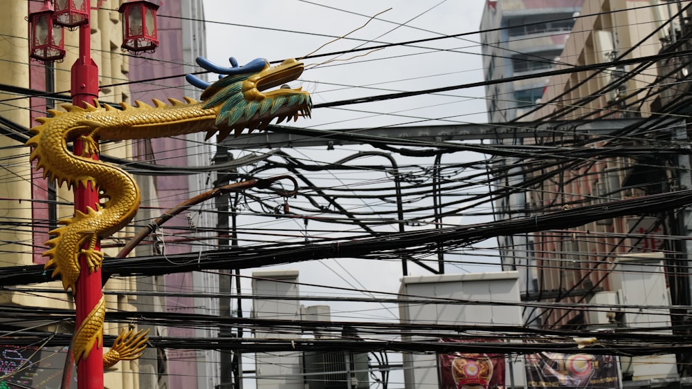 a dragon statue on a pole in the middle of a city