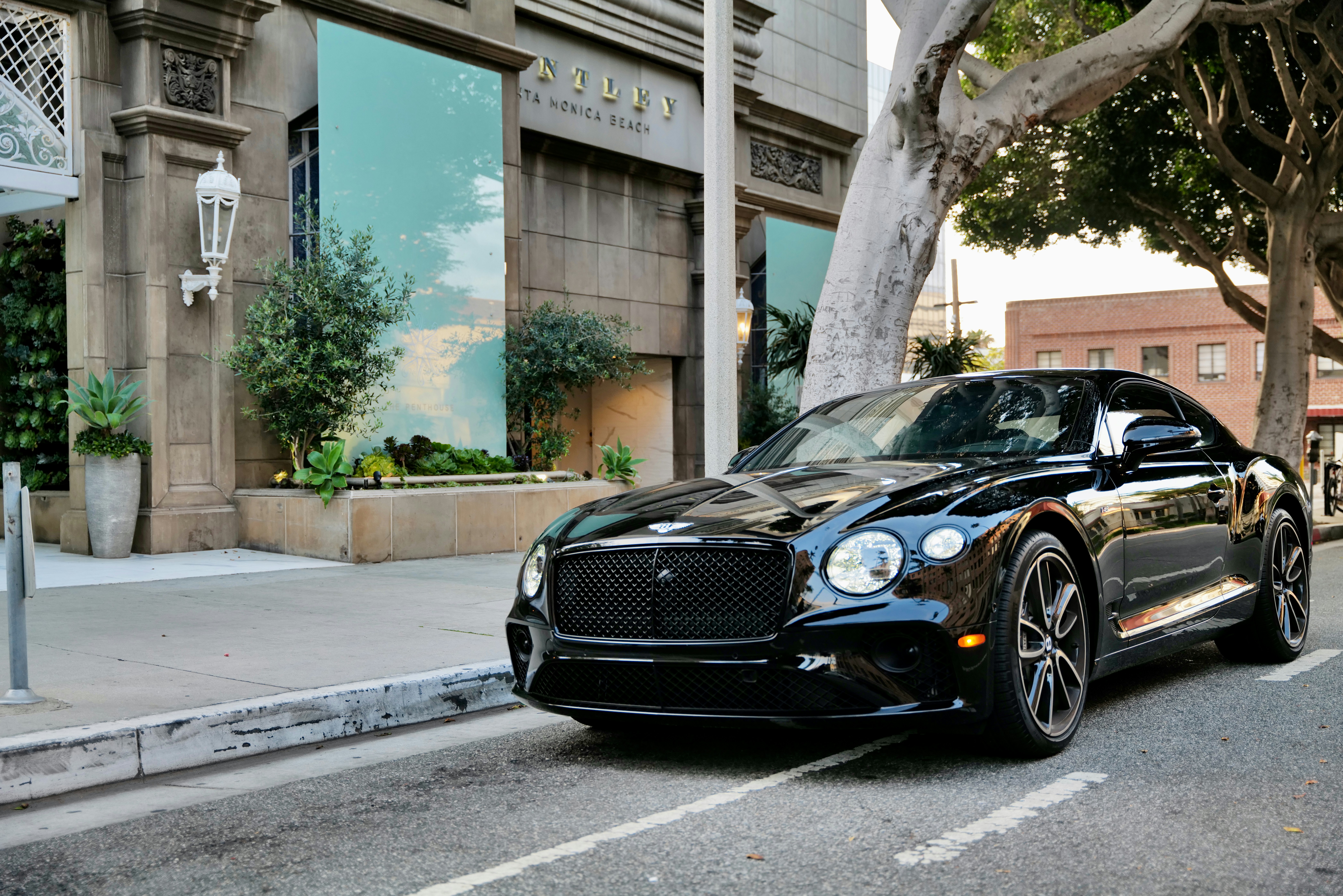 a black car parked on the side of the road