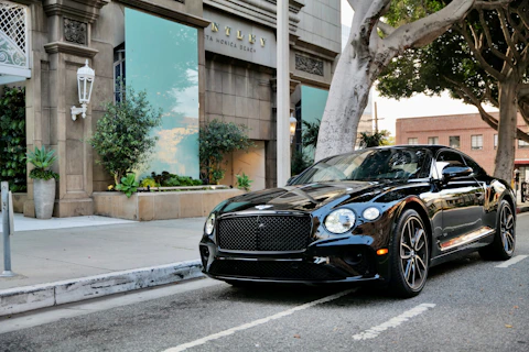 a black car parked on the side of the road