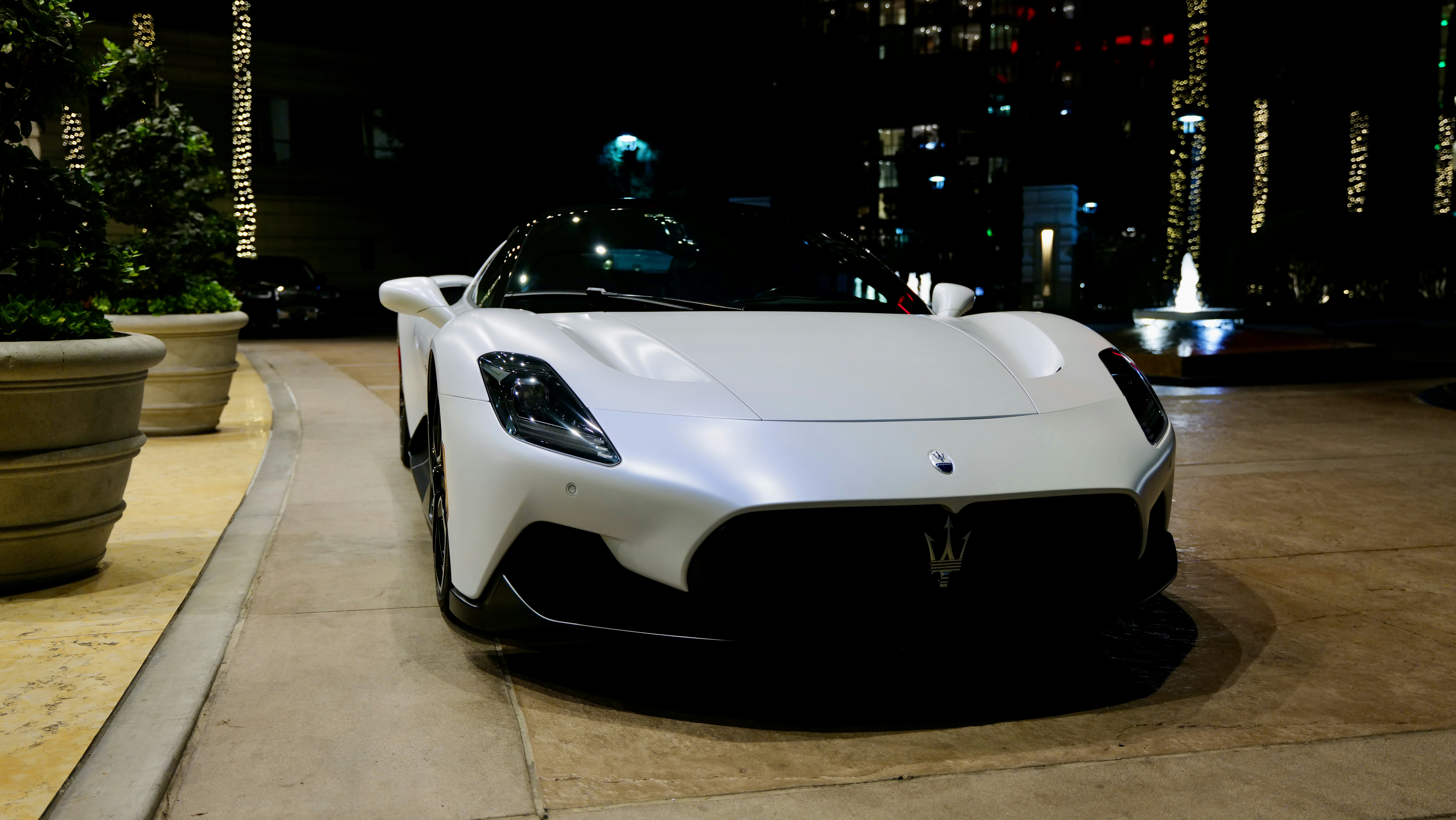 a white sports car parked in front of a building