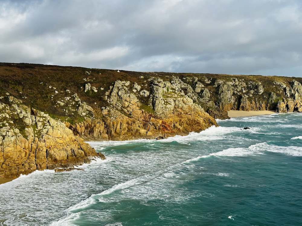 a view of the ocean and cliffs from a cliff