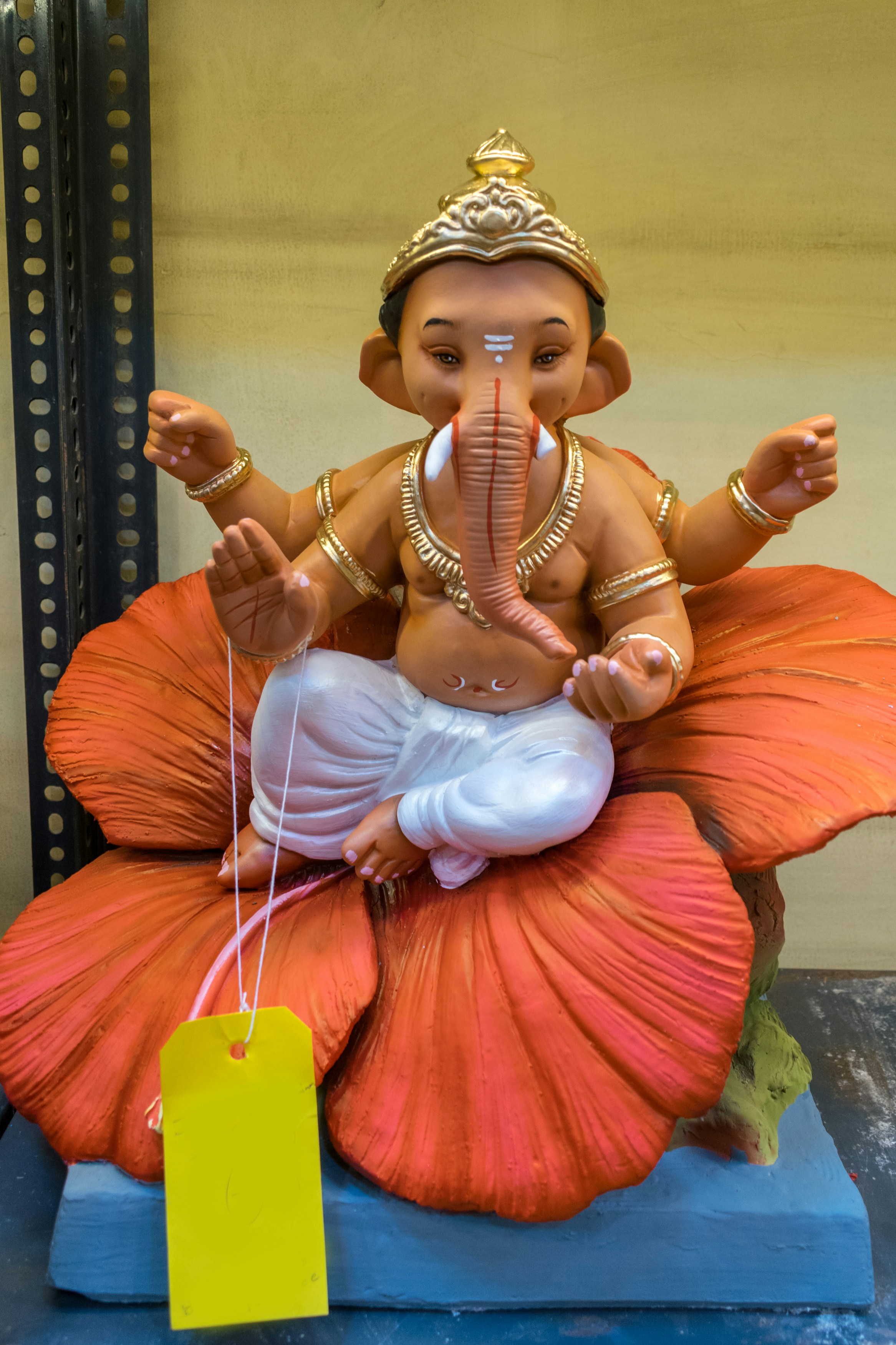 a statue of a ganesh sitting on top of a flower
