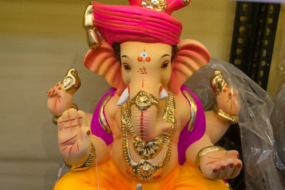a statue of an elephant with a pink turban on its head