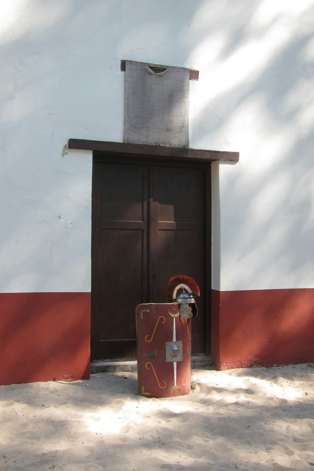 a red suitcase sitting in front of a door