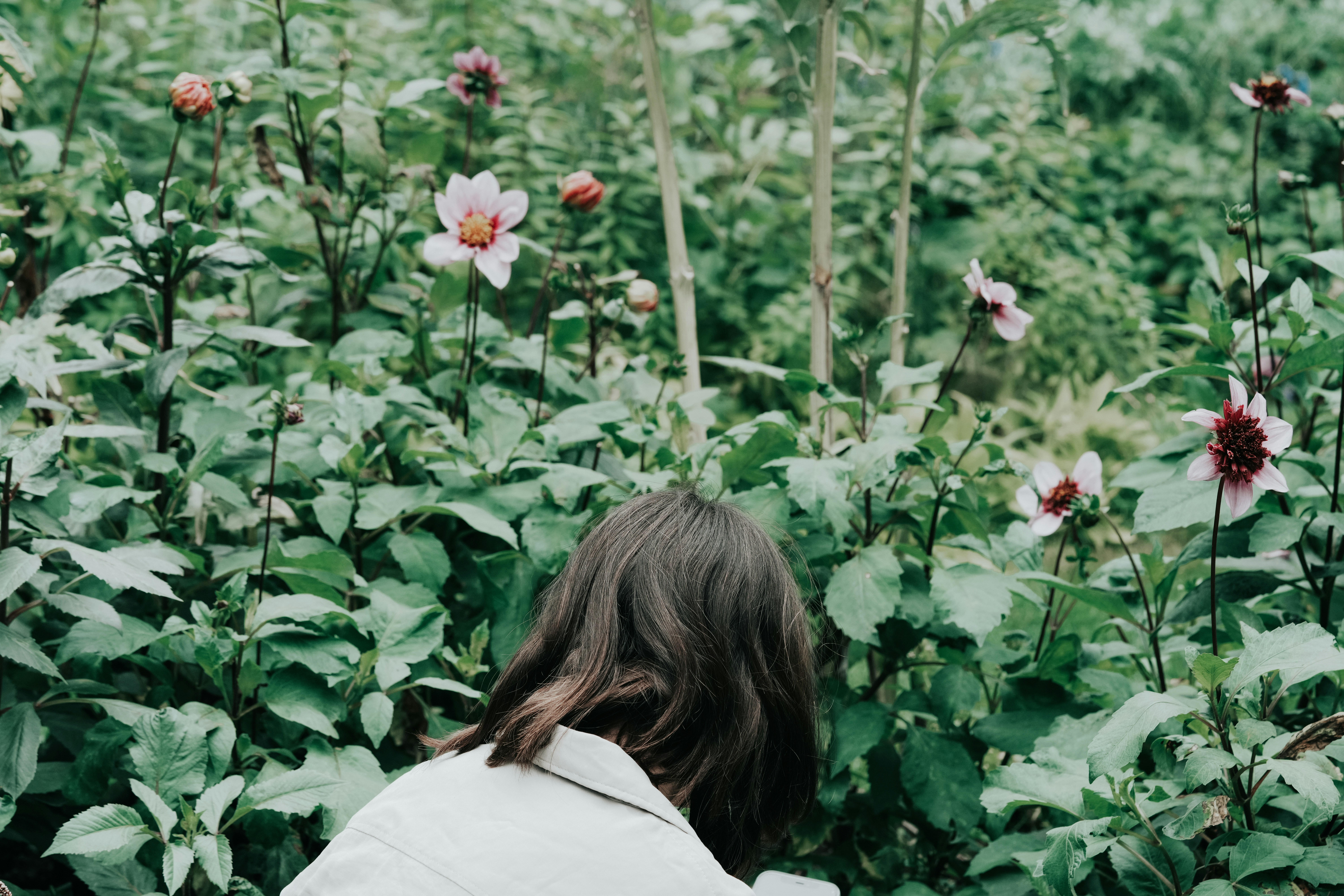 a woman standing in a field of flowers
