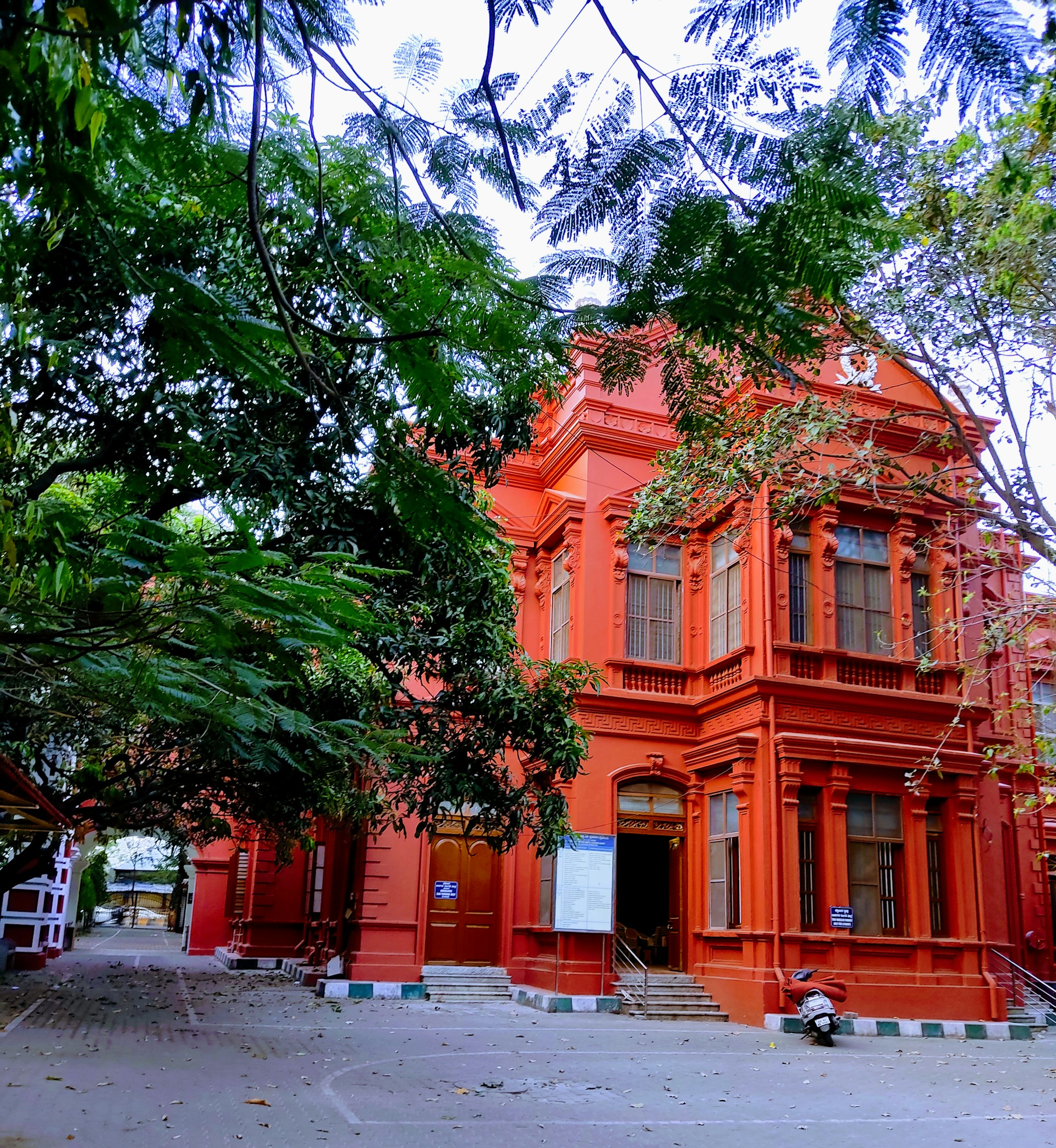 a large orange building with a clock on the front of it