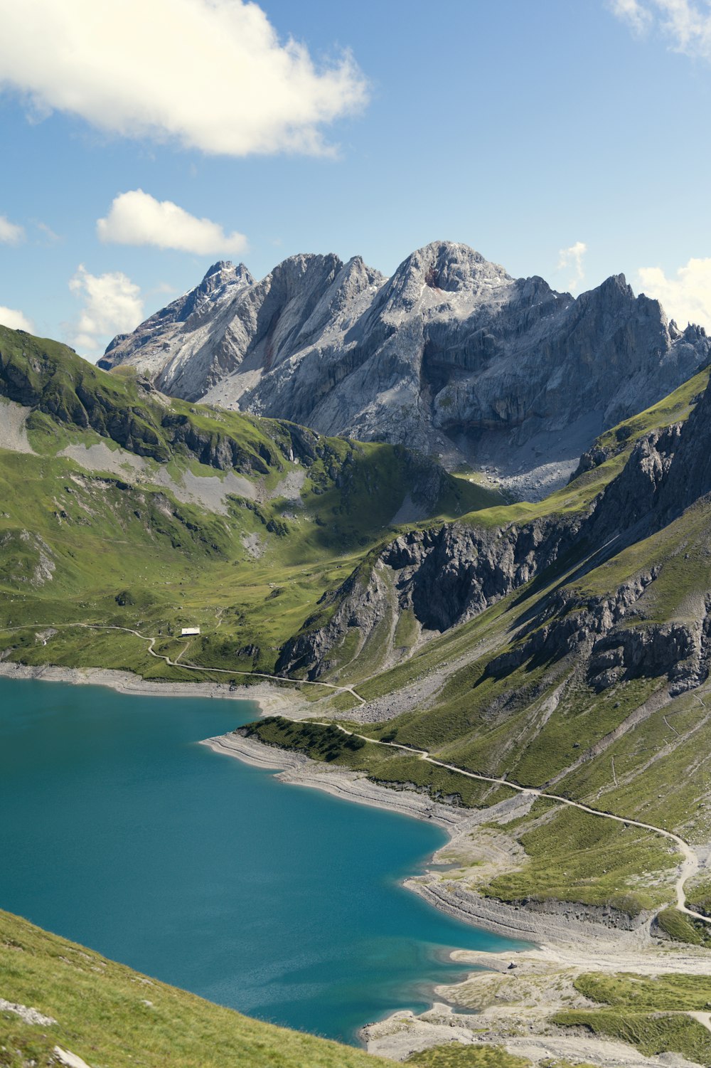 a mountain range with a lake in the foreground