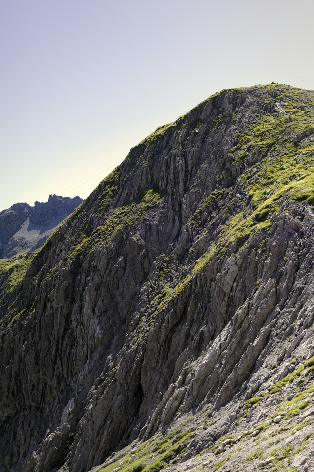 a person walking up a mountain side with a backpack