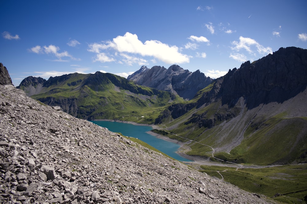 a view of a mountain lake from the top of a hill