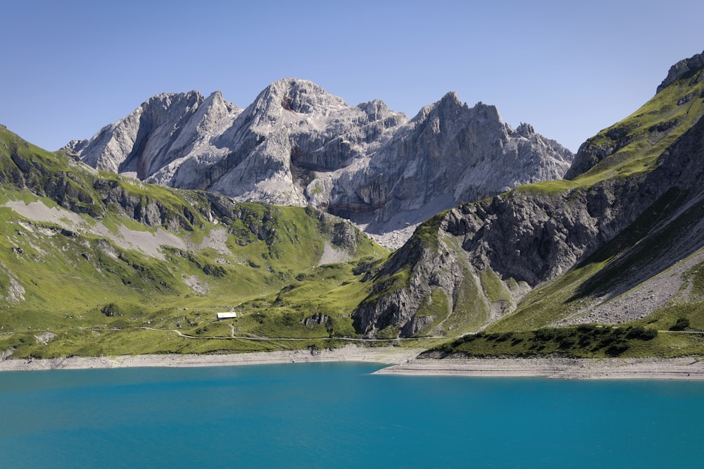 a mountain range with a lake in the foreground