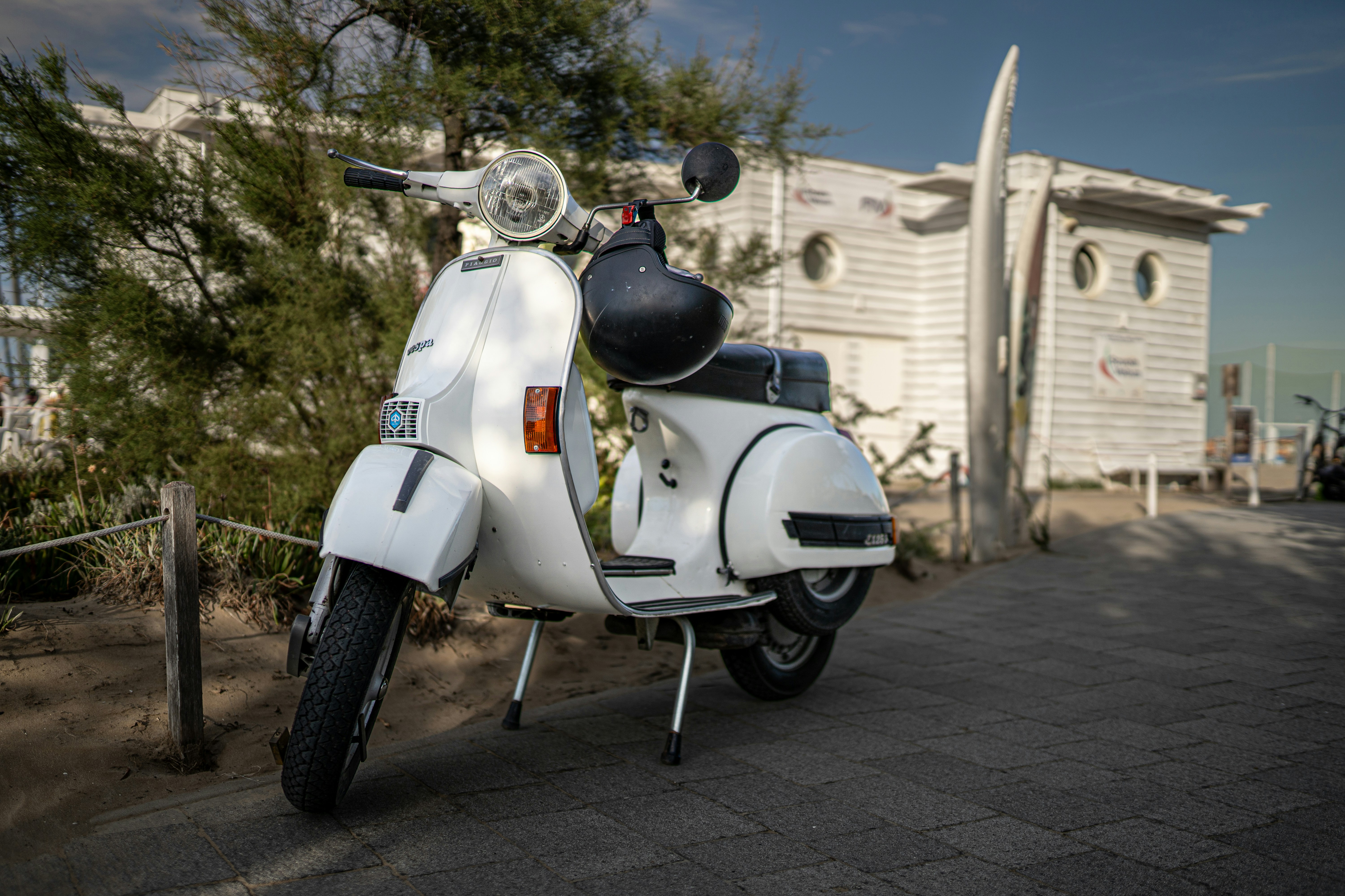 a white scooter parked in front of a building