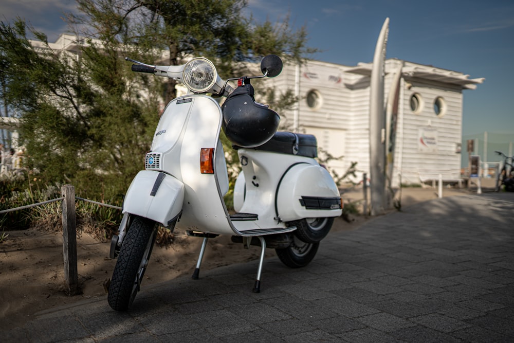 a white scooter parked in front of a building