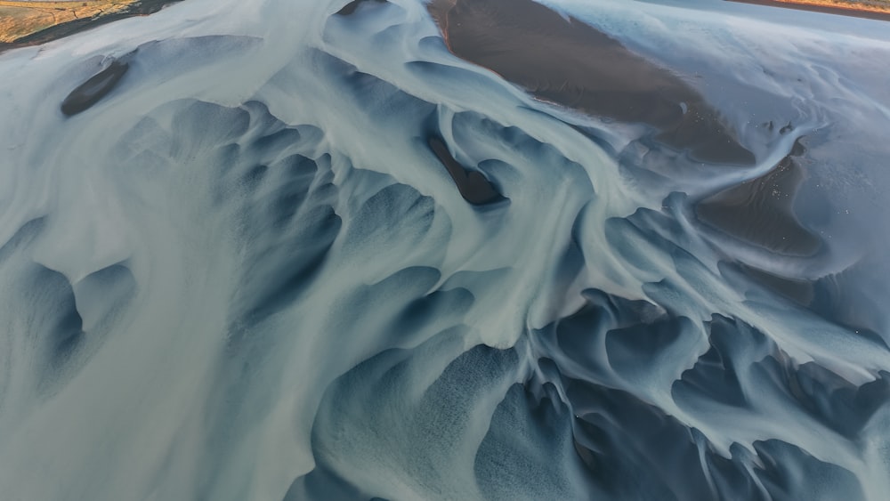 an aerial view of a river flowing through a valley