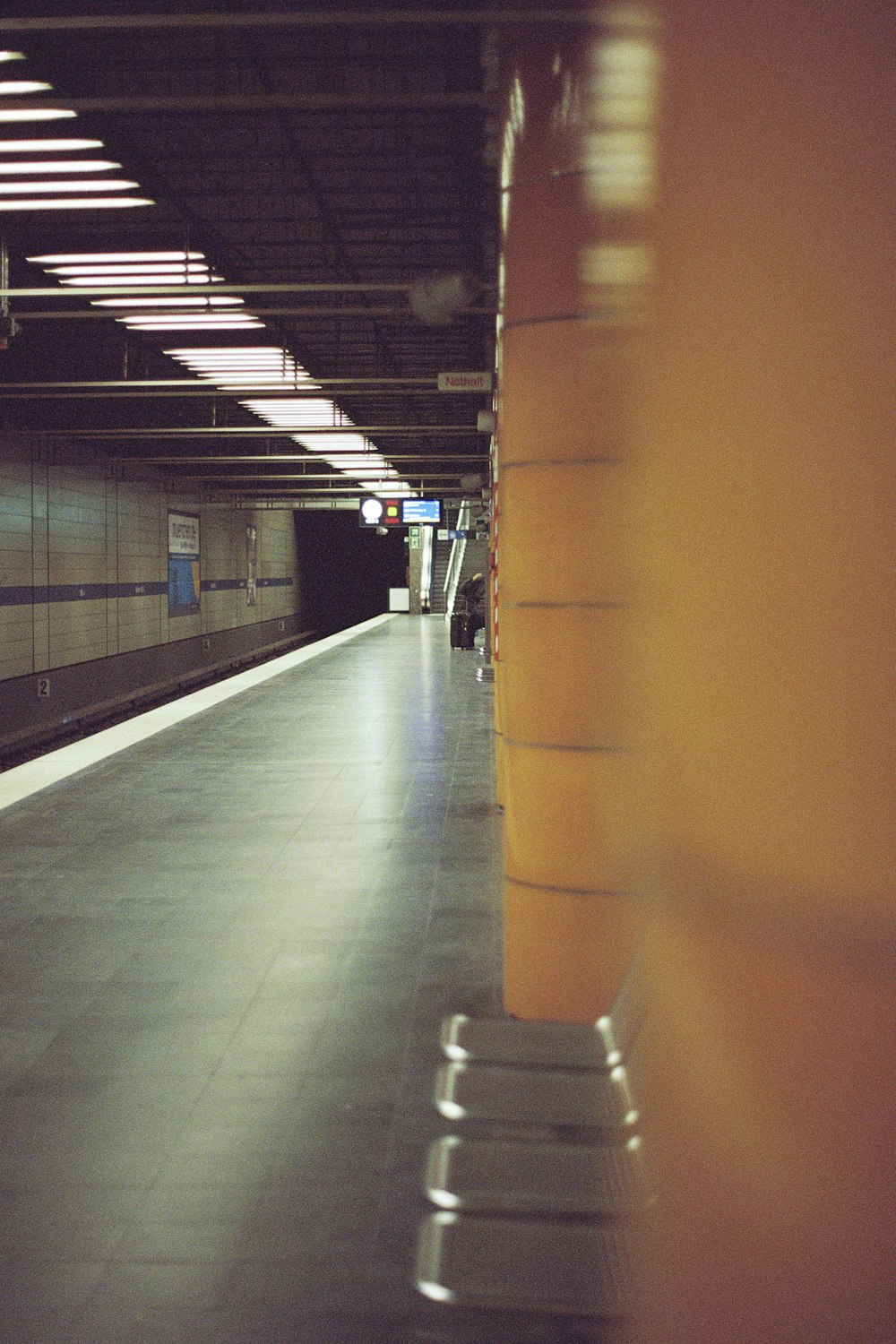 a subway station with a bench in the foreground