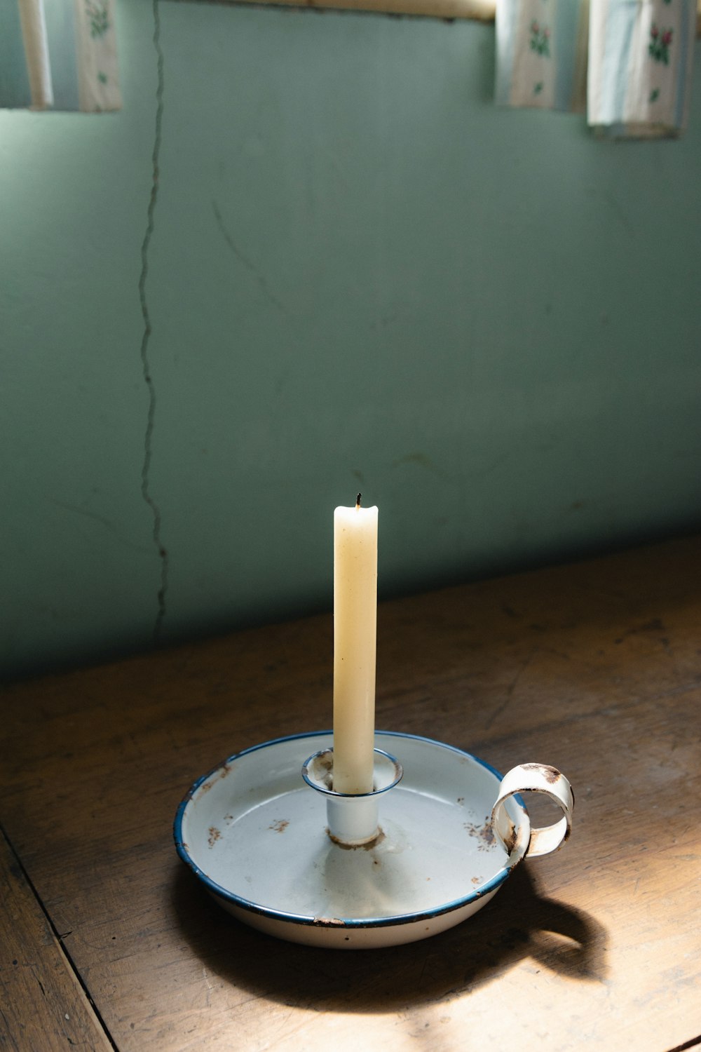 a white candle sitting on top of a wooden table