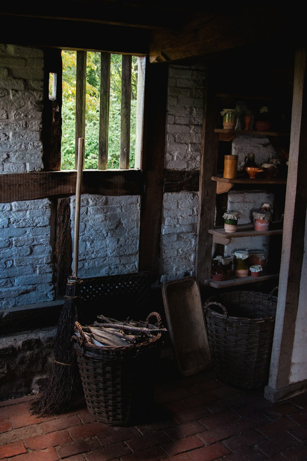 a room with a brick wall and a window