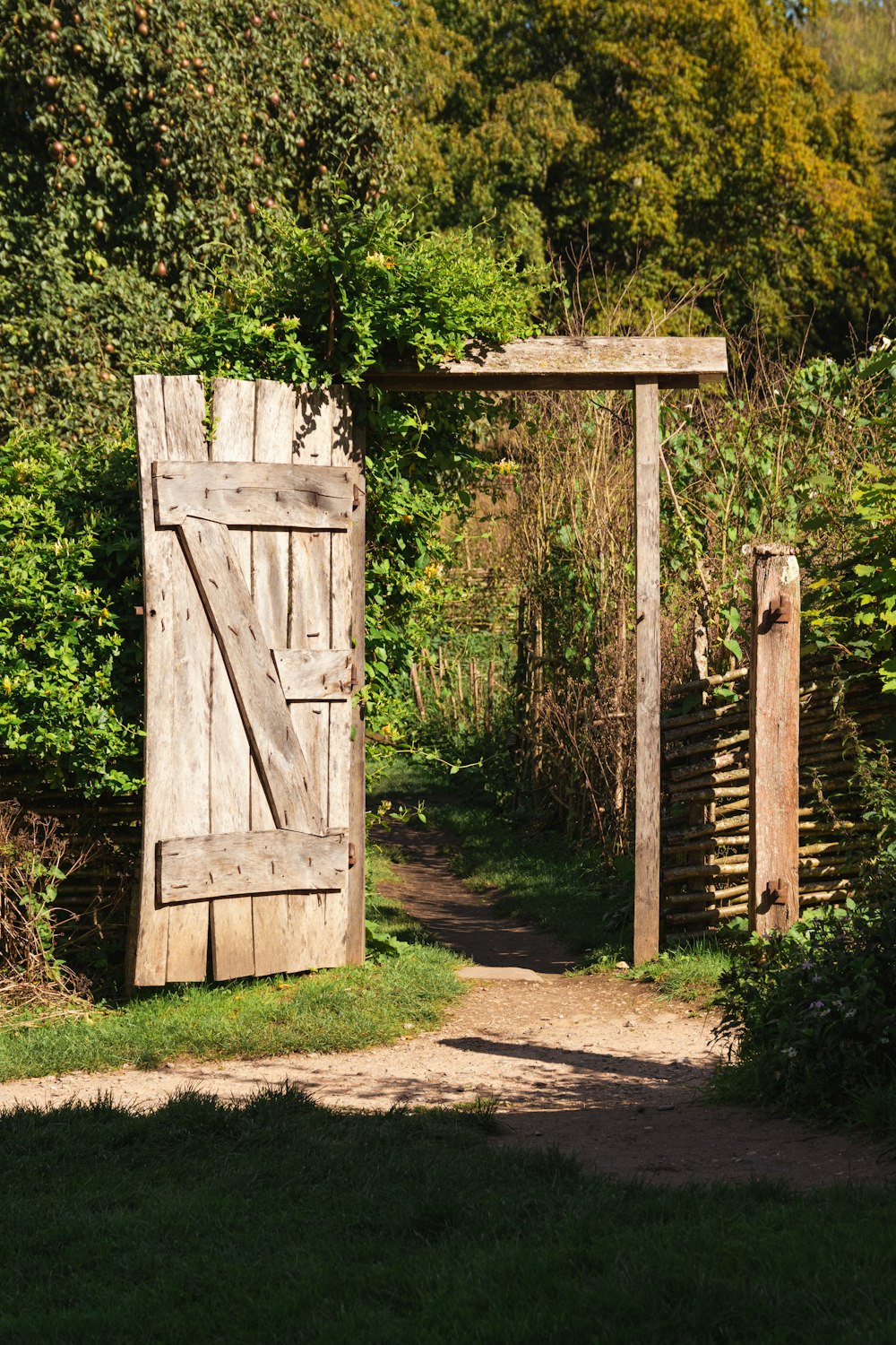 a wooden gate with a wooden gate in the middle of it