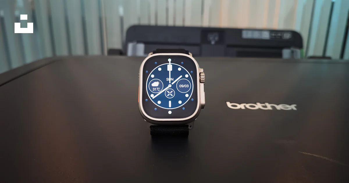 A smart watch sitting on top of a table photo – Free Office Image on ...