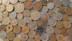 a pile of different coins sitting on top of each other