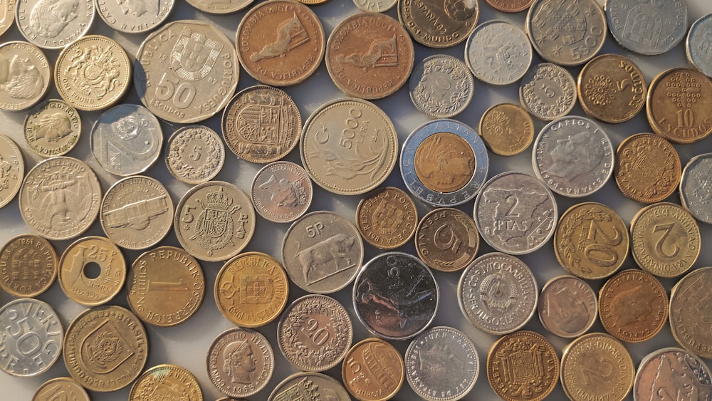 a pile of different coins sitting on top of each other