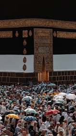 a large group of people holding umbrellas in front of a building