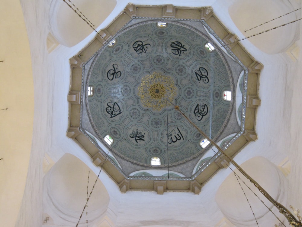 the ceiling of a building with a clock on it