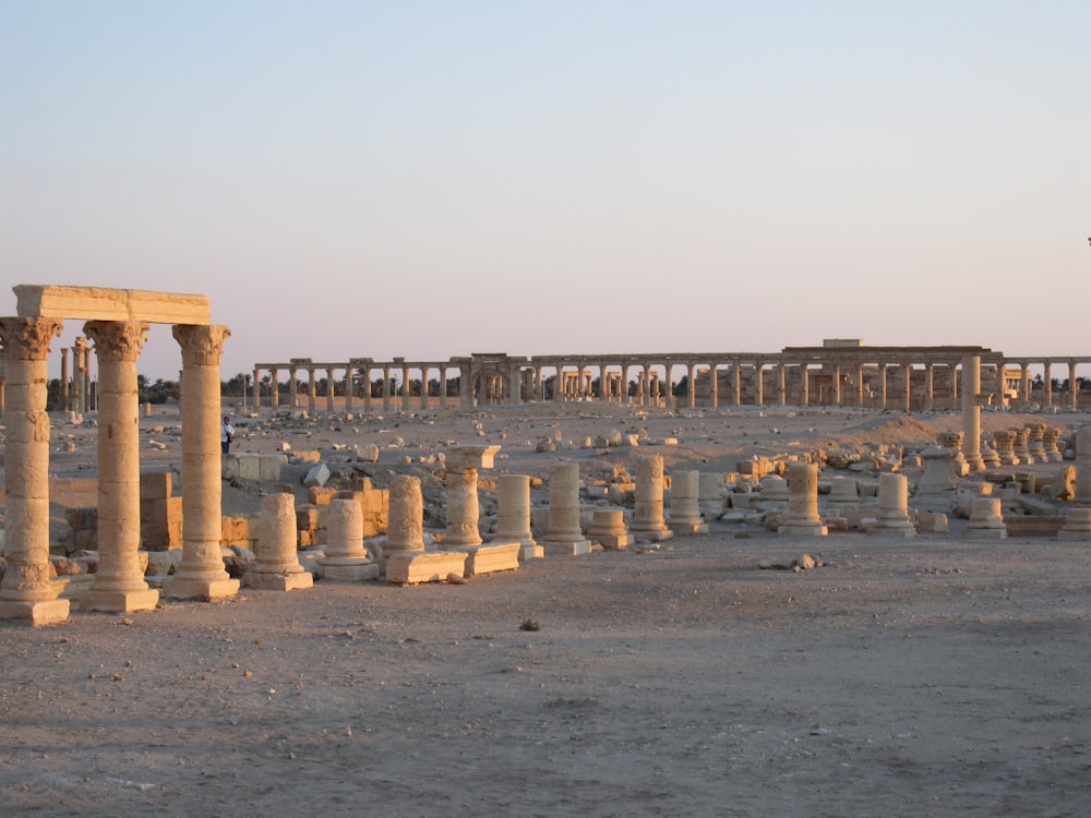 a large group of pillars in the middle of a desert
