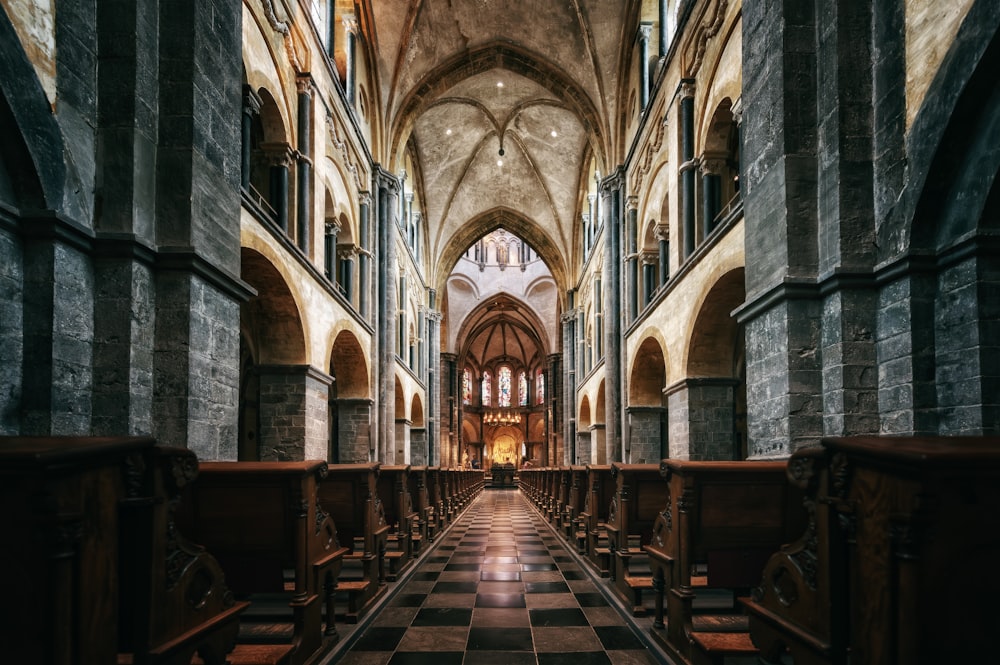 a cathedral with a checkered floor and pews