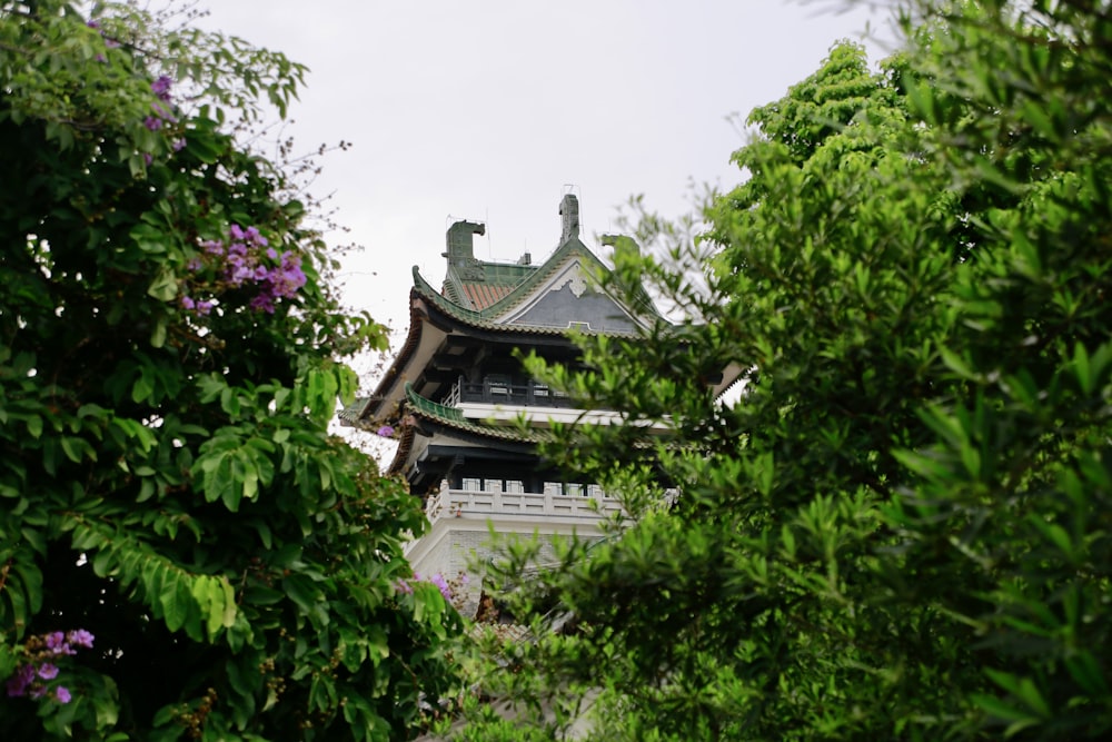 a tall tower surrounded by trees and bushes