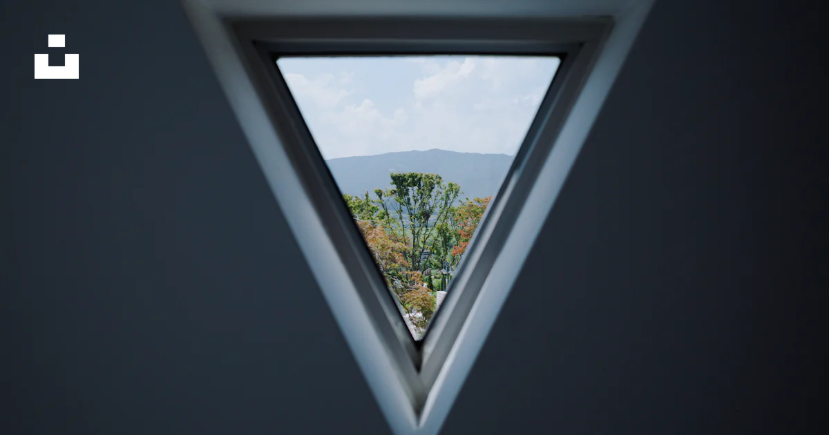 A triangle shaped window with a view of a mountain photo – Free Cafe ...