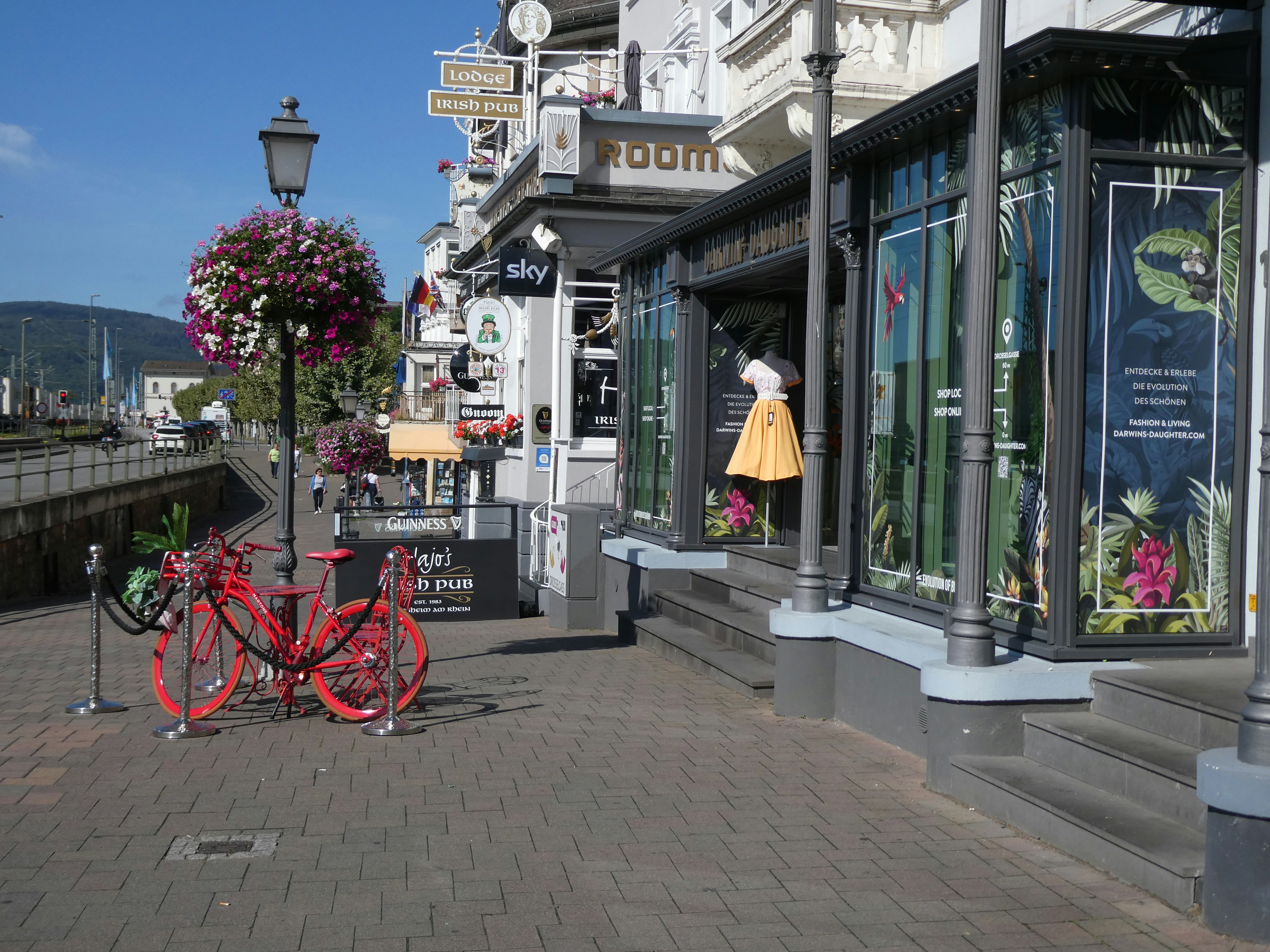 a red bike parked on the side of a street