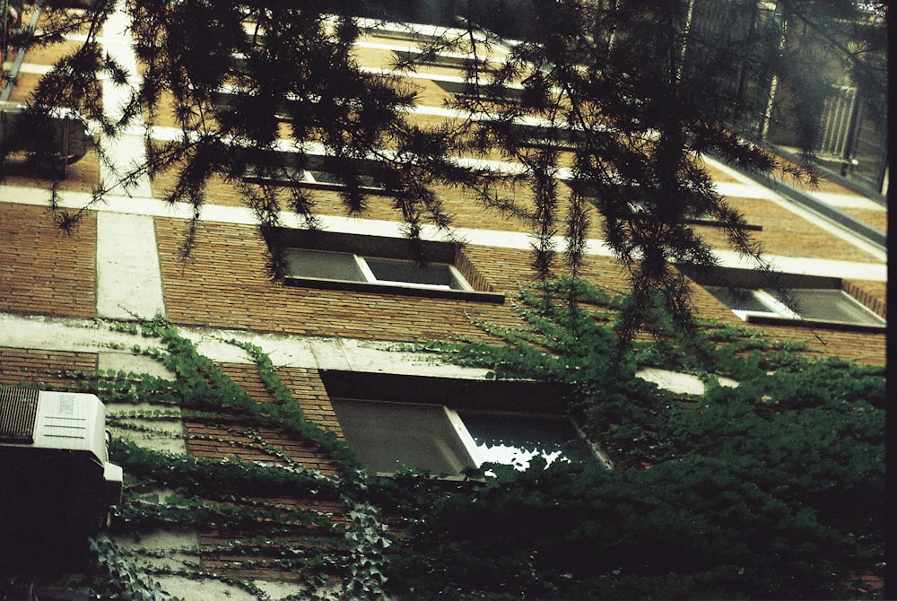 a tall building with lots of windows next to trees