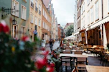 A charming European street lined with boho-chic cafes and earthy green plants spilling from window boxes.