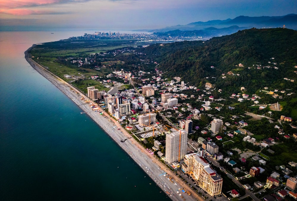 an aerial view of a city next to the ocean