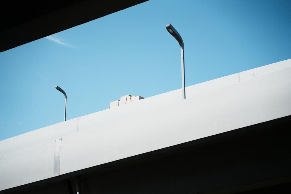 a couple of street lights sitting on the side of a building