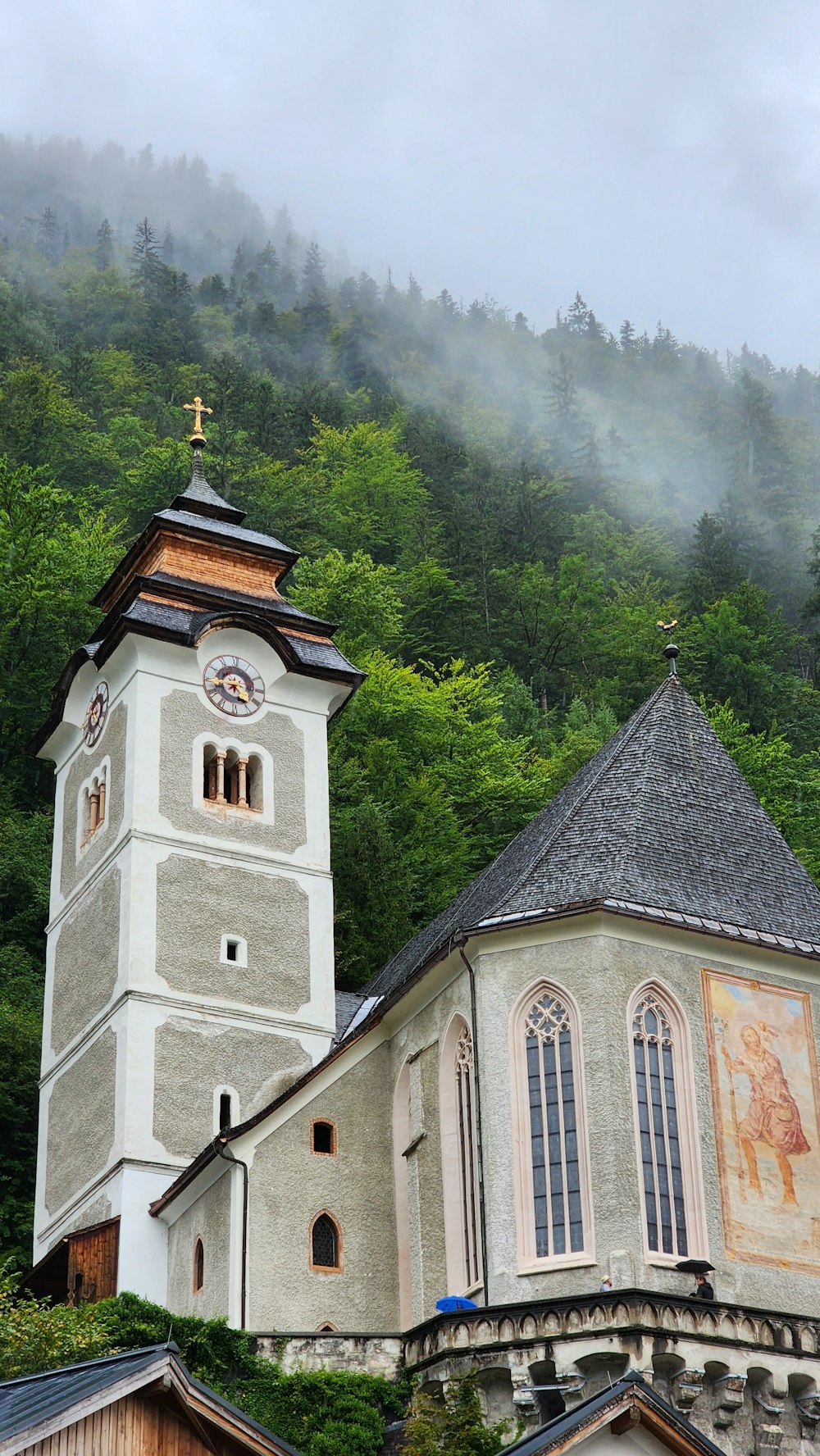 a church with a steeple surrounded by trees