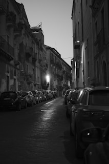 Black and white cinematic shot of a Miami street at dusk, capturing authentic urban life.