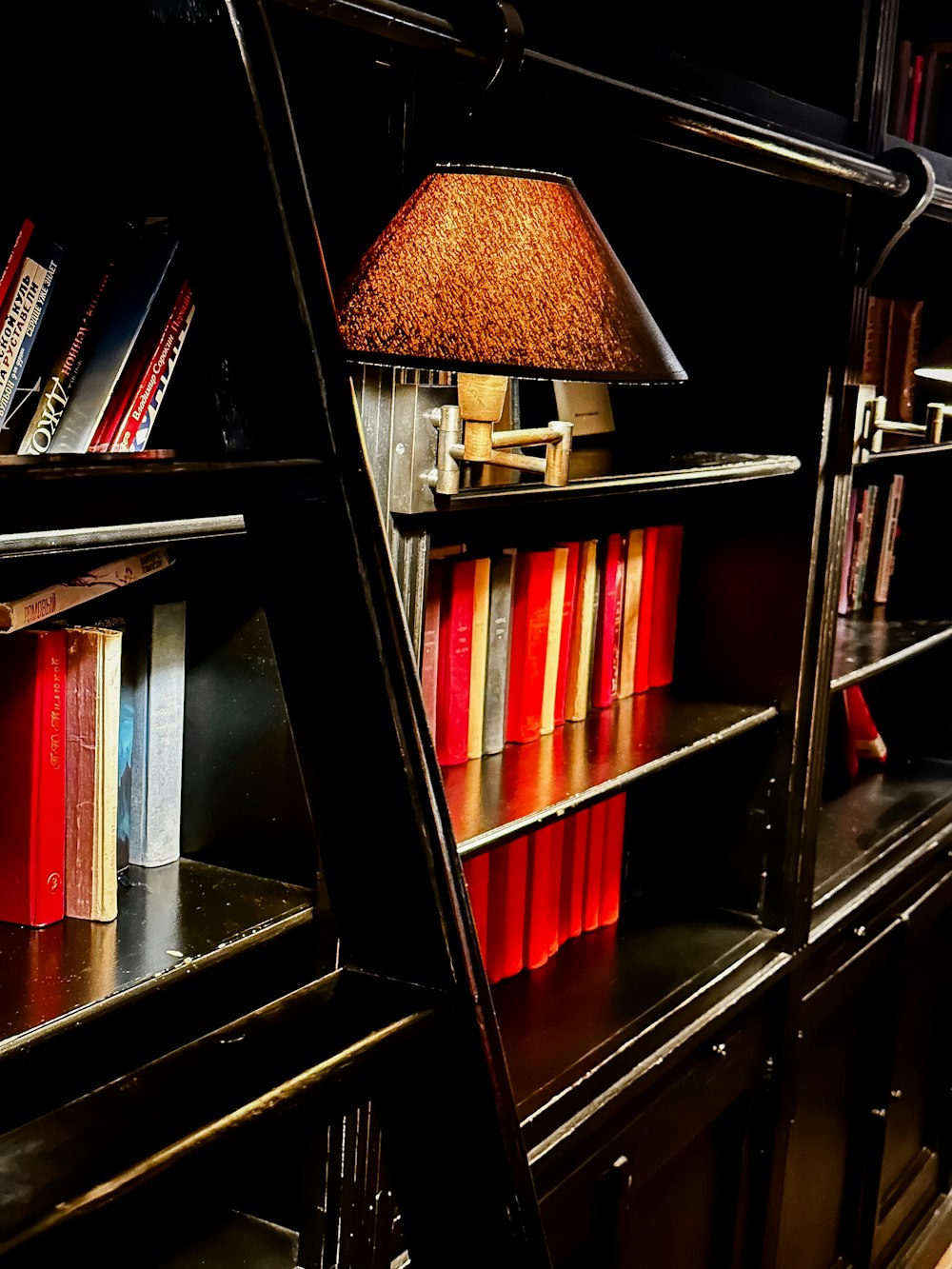 a bookshelf with a lamp on top of it