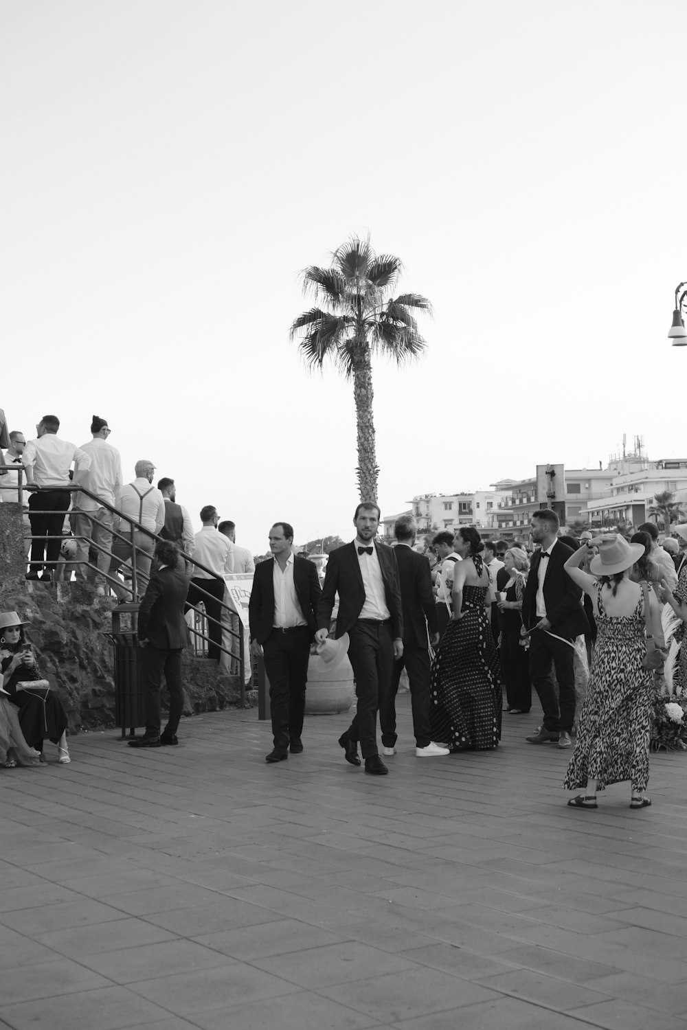 a group of people standing next to each other on a sidewalk