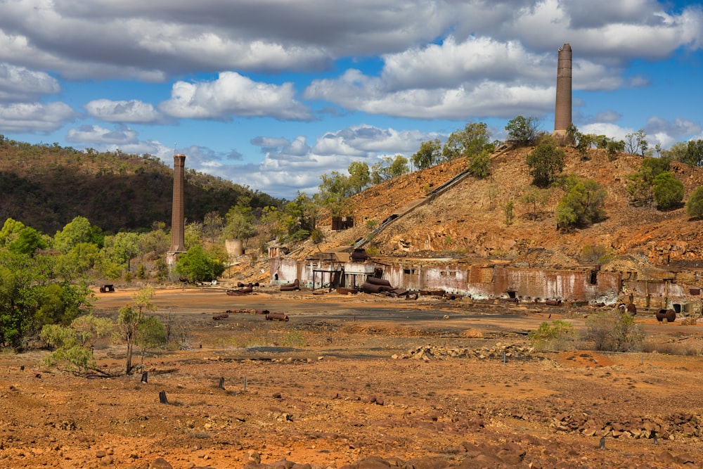 an old factory sits on top of a hill