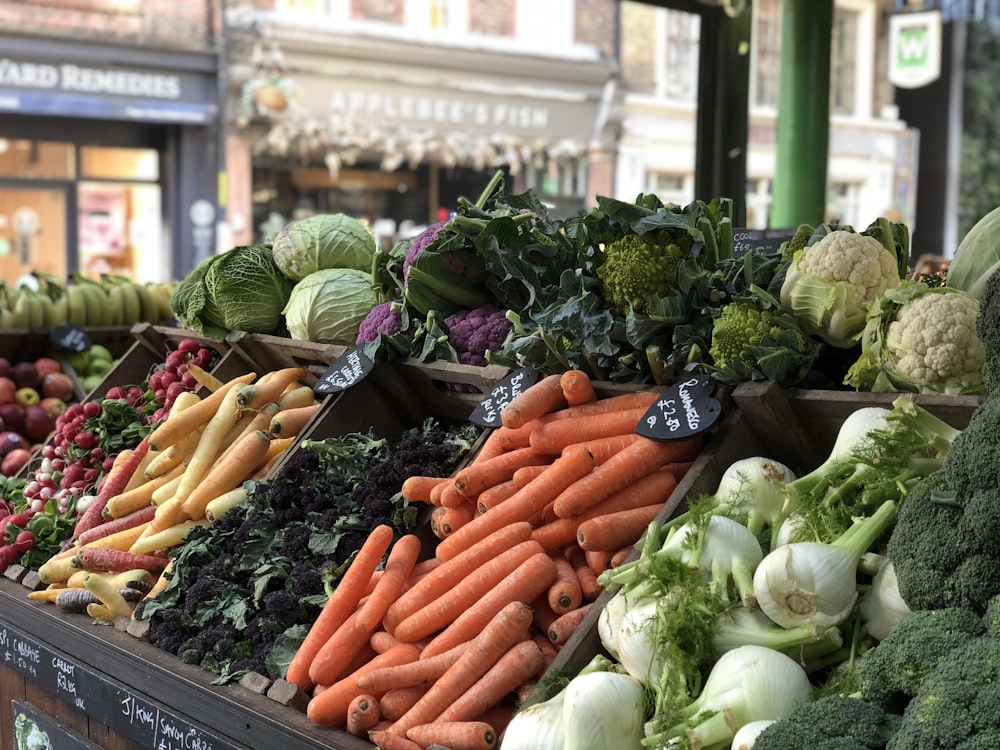 a variety of vegetables are on display at a market