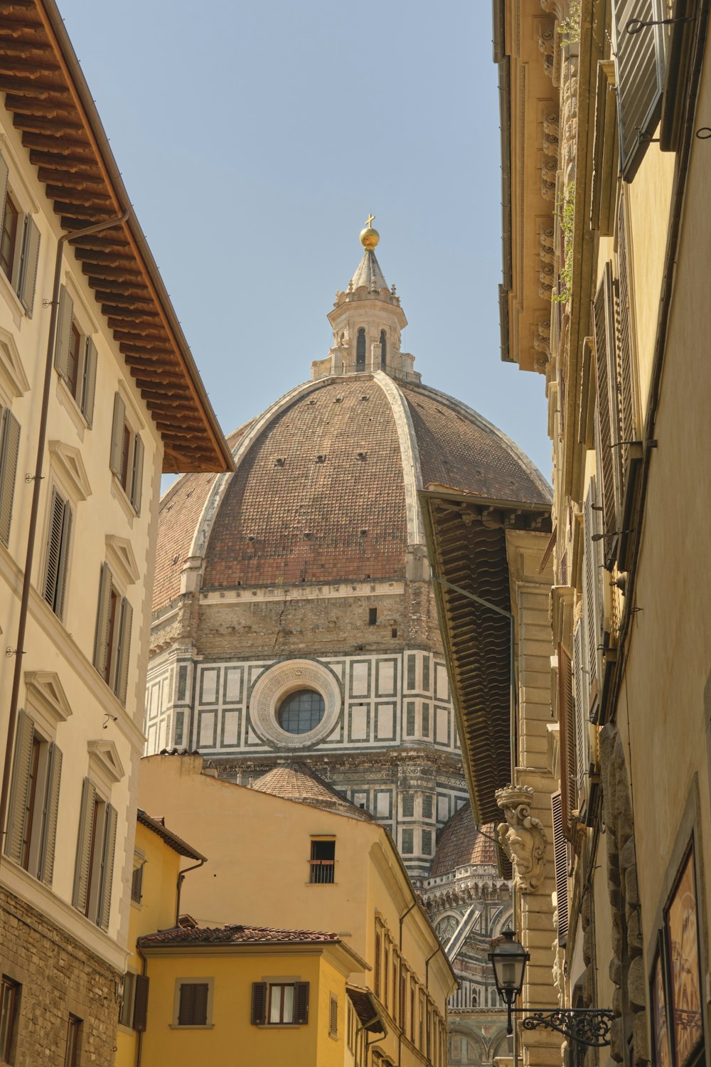 a building with a dome in the middle of a street