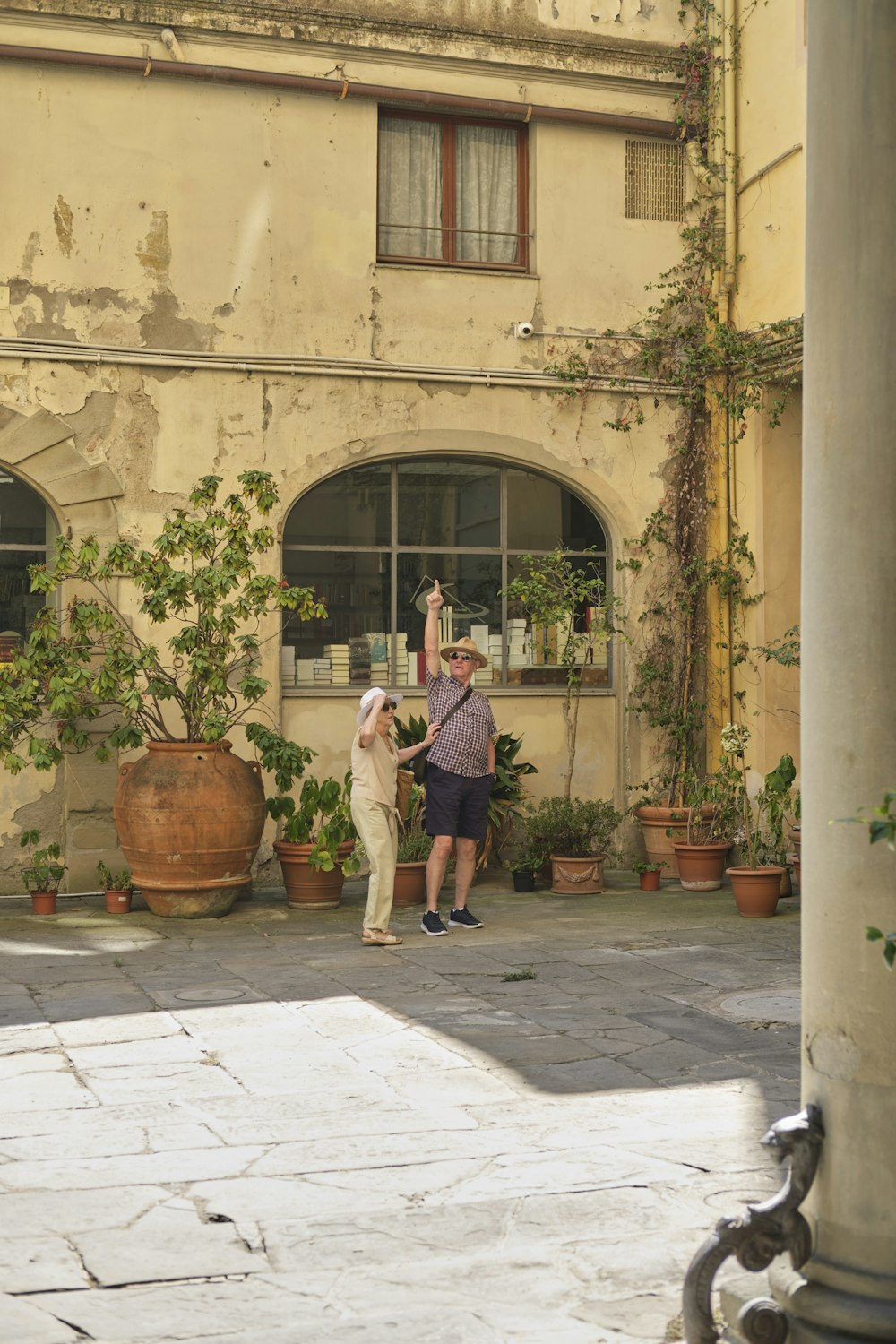 a couple of people that are standing in front of a building